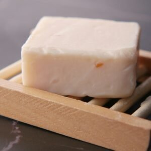 a block of soap sitting on top of chopsticks